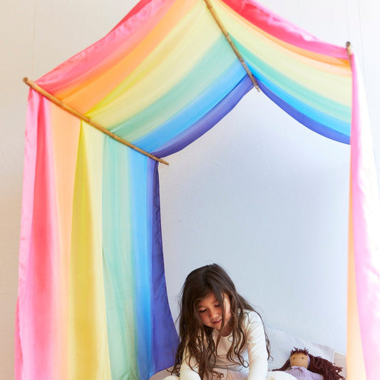 A child sitting inside a colorful canopy sarasilk
